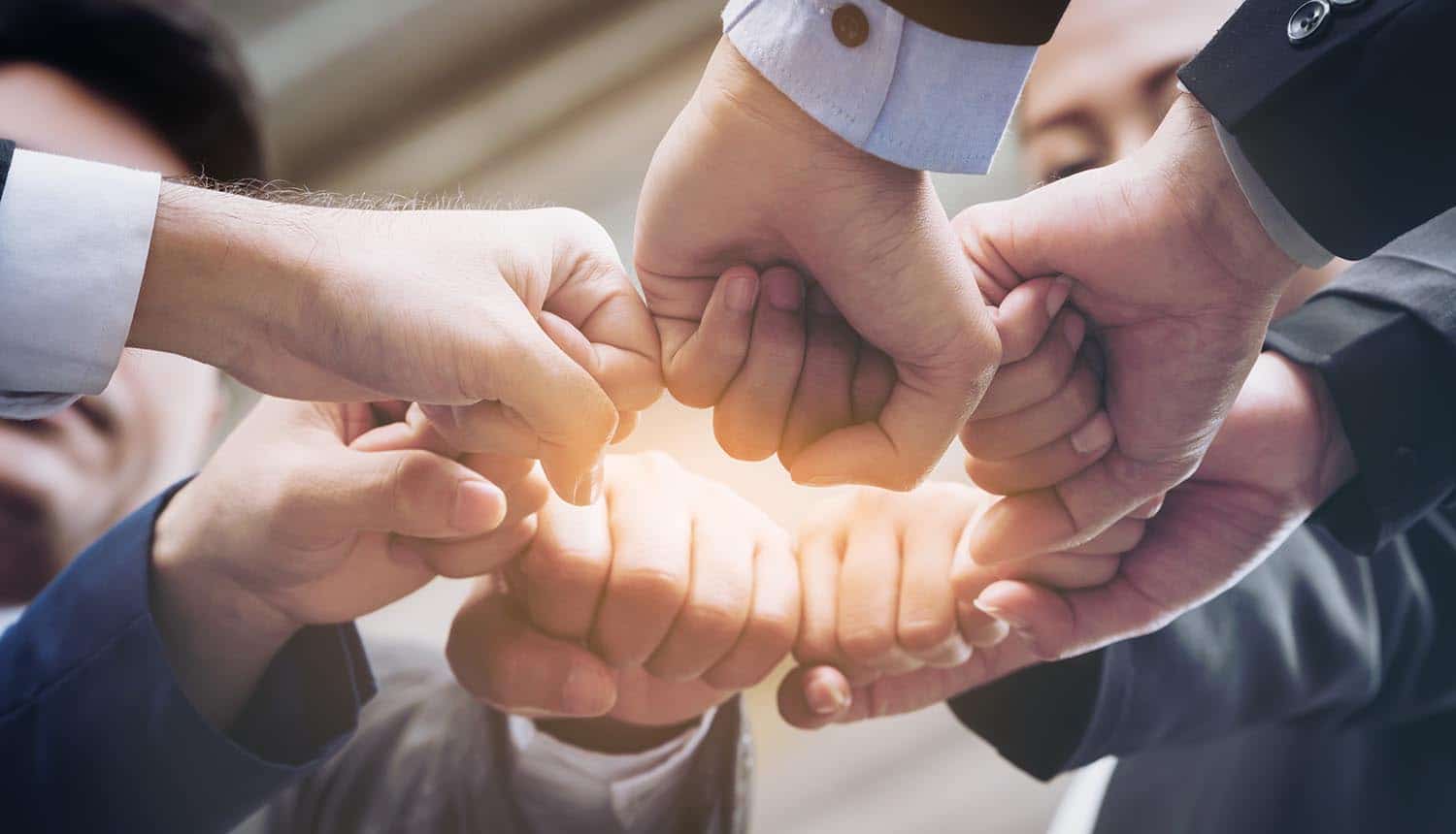 Business team joining hands showing teamwork and success