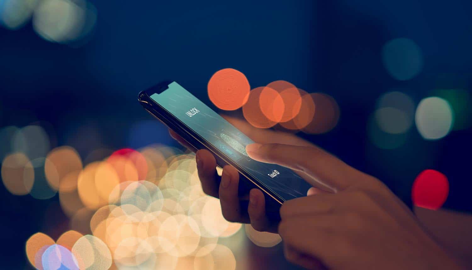 Close-up of hands scanning fingerprint on smartphone showing data breach of customer data via CRM software