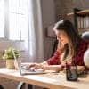 Girl teleworker works at home with a laptop using video conferencing platform