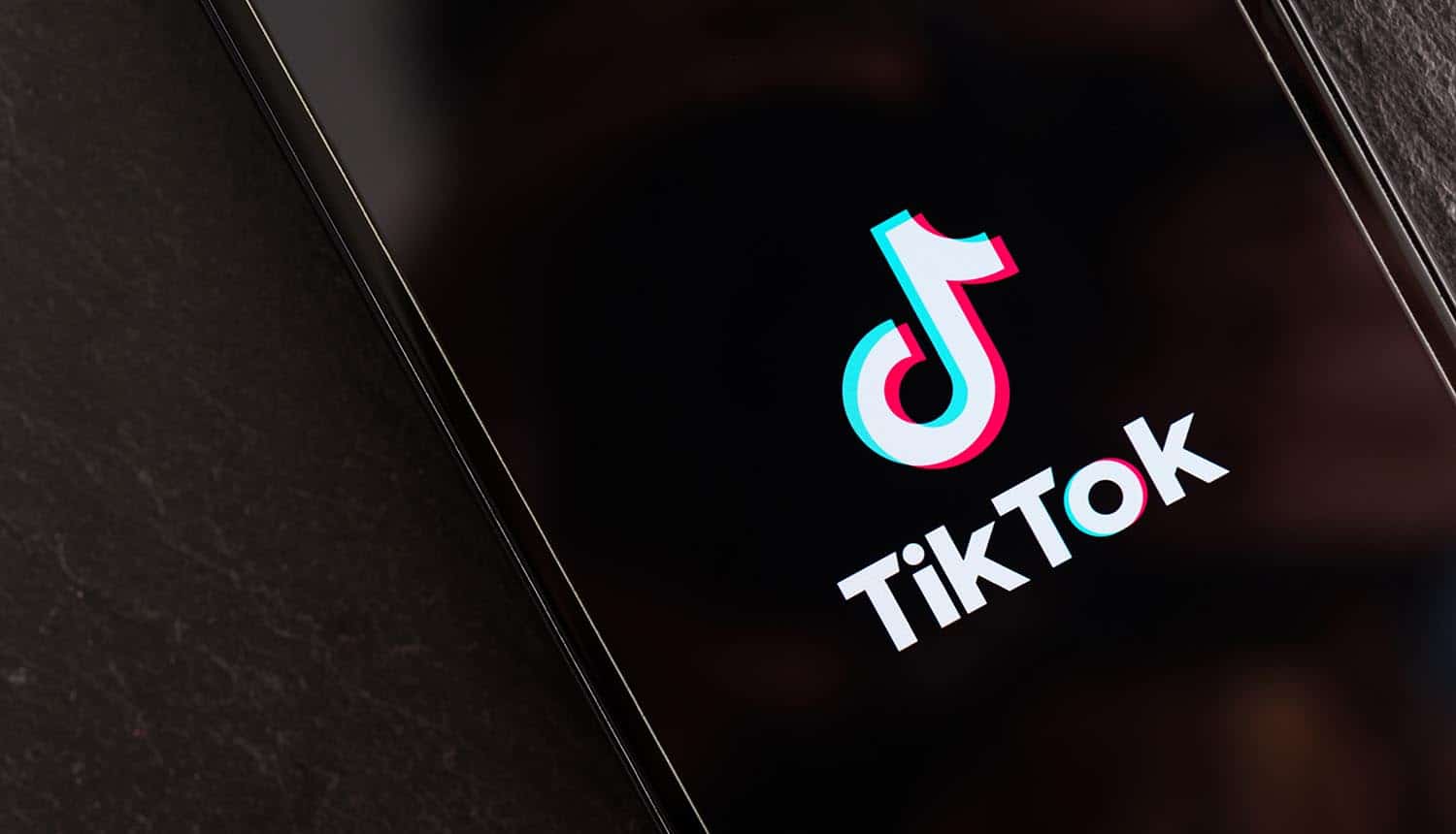 Logo of TikTok video sharing network on mobile phone