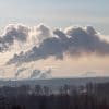 Smoke from the chimneys of a plant showing need for industrial cybersecurity
