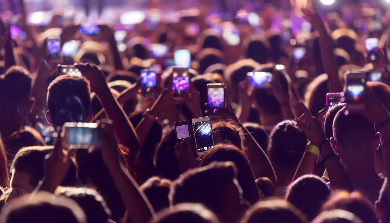 Hands with a smartphones records live music festival