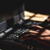 Hacker using laptop showing North Korea hackers exploiting VPN vulnerability