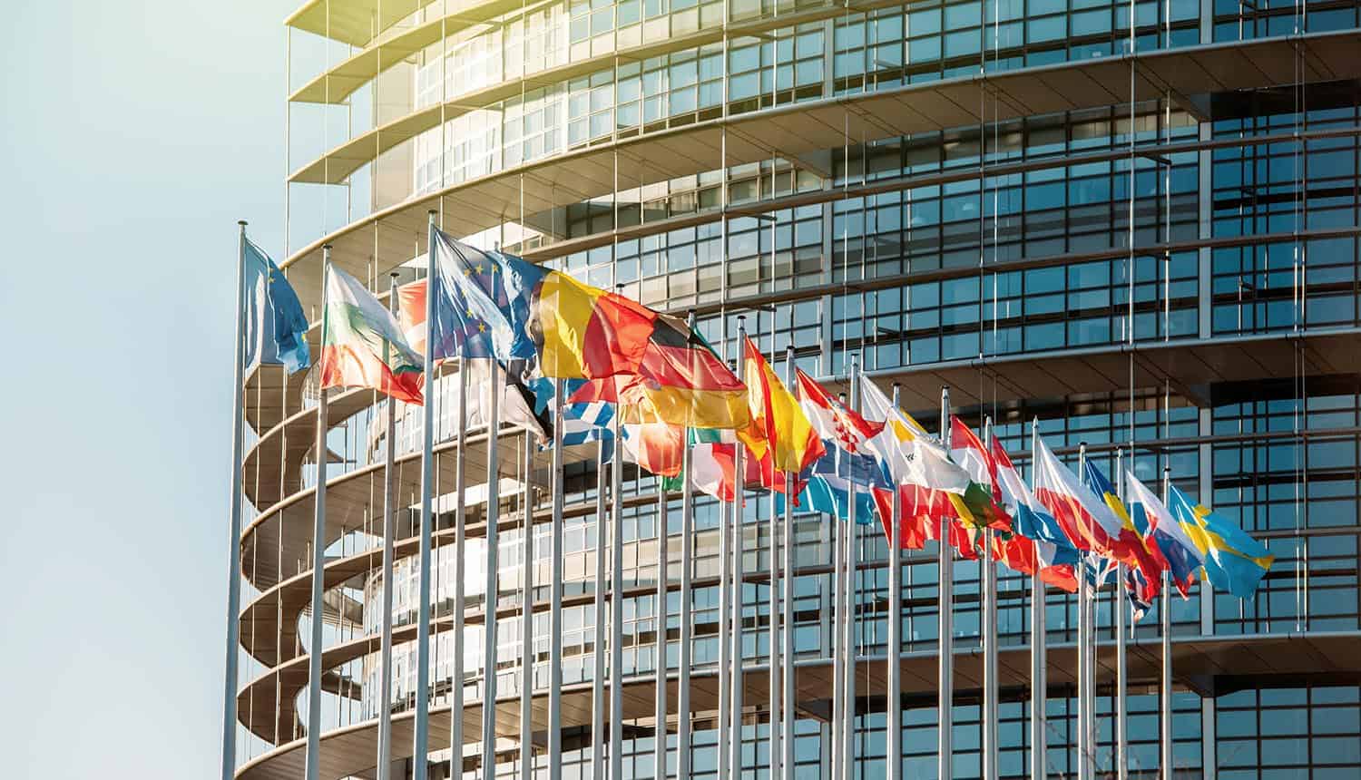 European Parliament building with flags waving showing privacy commissioner complain of GDPR