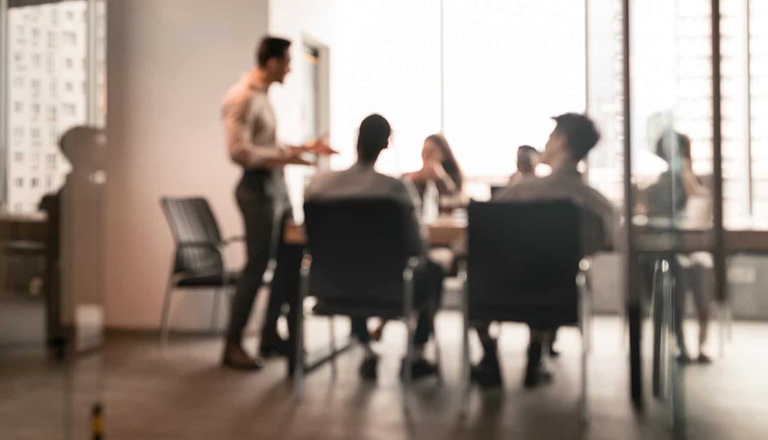 Colleagues having meeting in boardroom showing ransomware issue