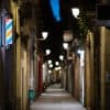 Blurred downtown alley at night showing network access sale on underground forums by cybercriminals