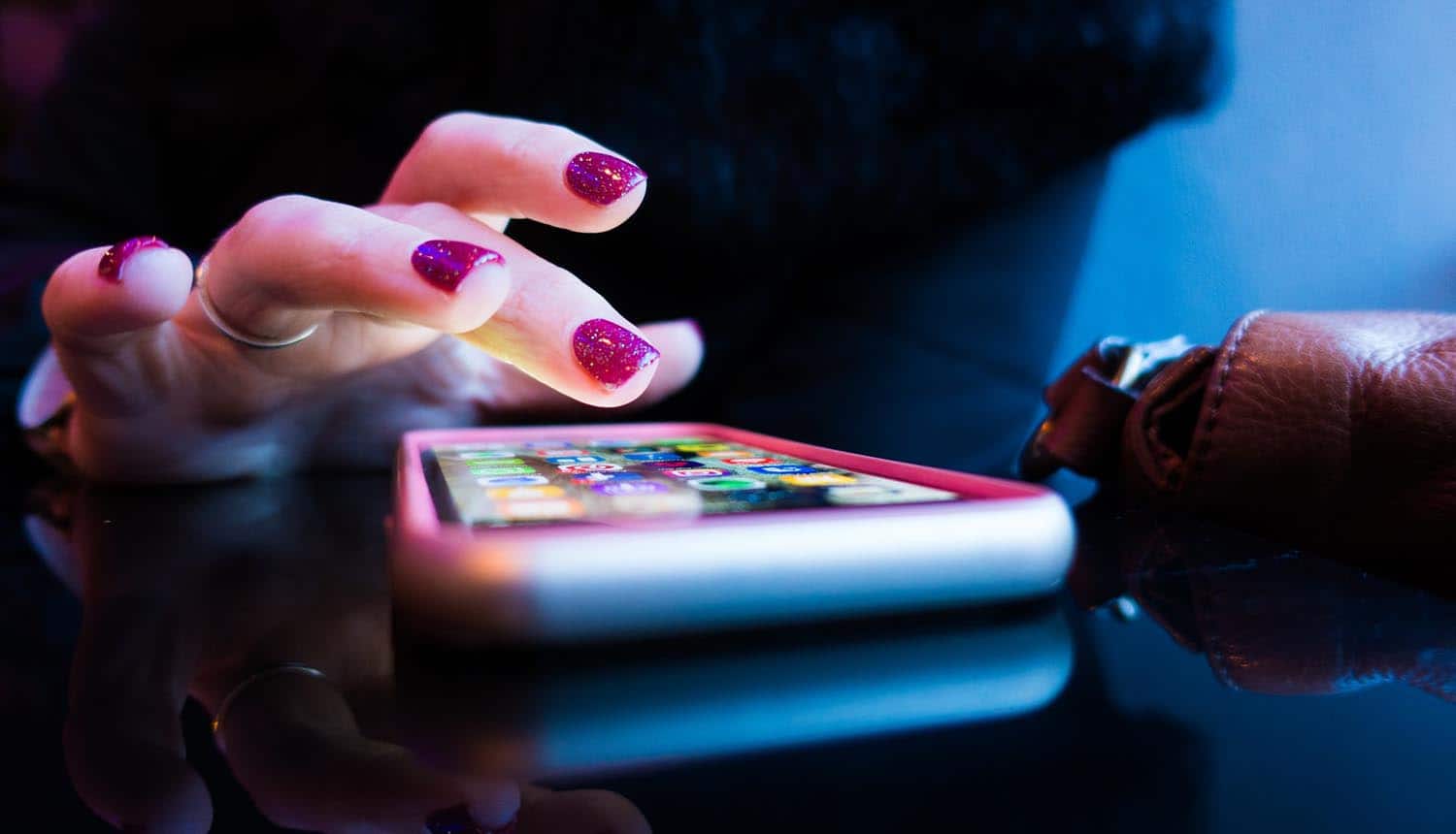 Woman's finger touching smartphone