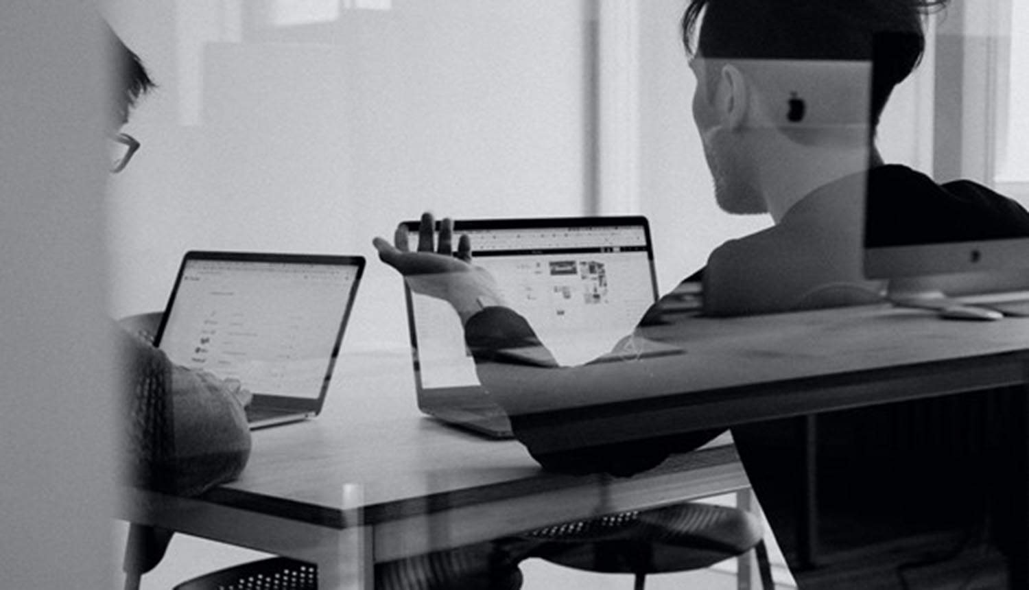 Team discussing over laptop