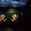 Hacker coding at night showing ransomware groups