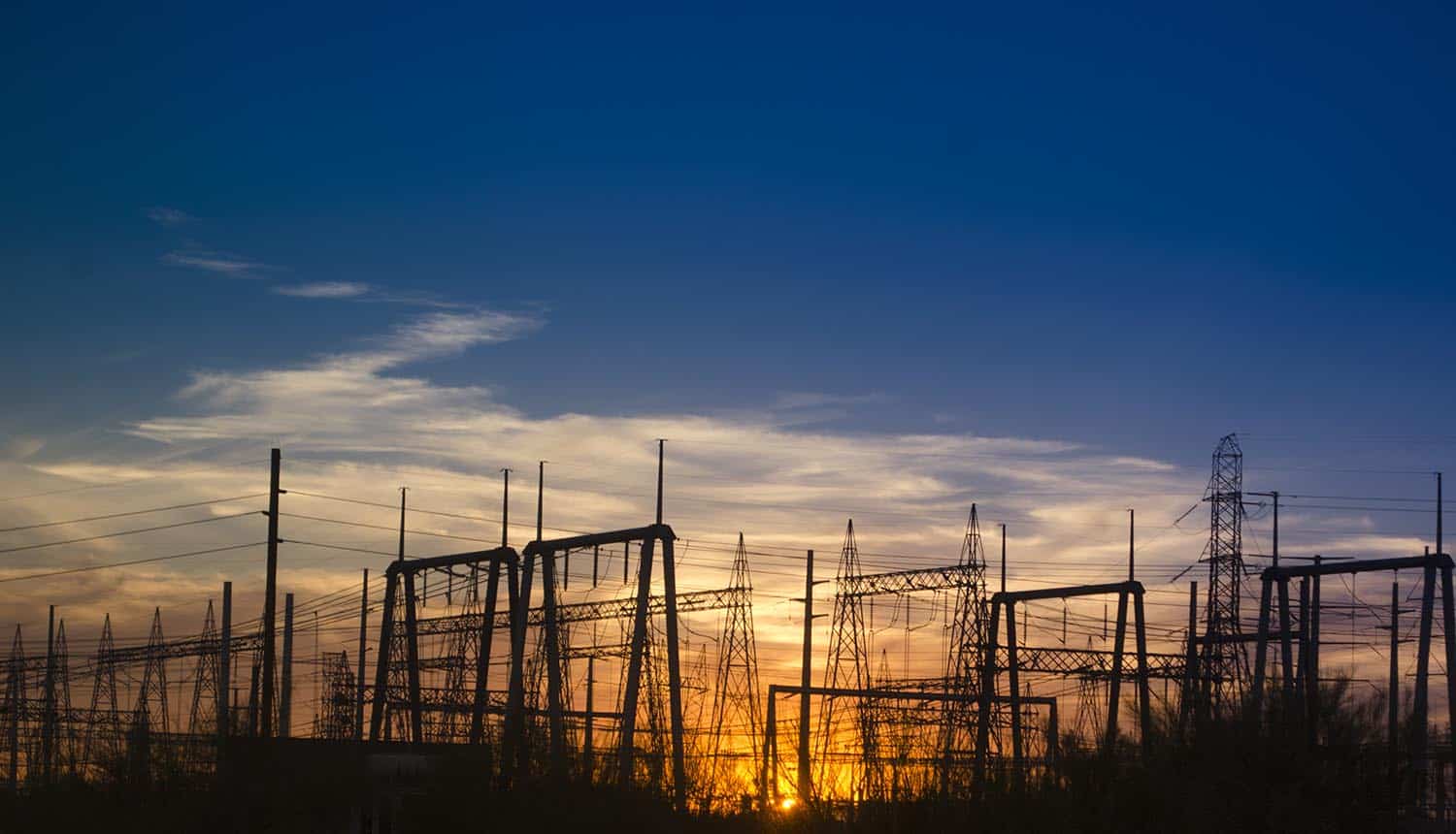 Electricity power generating station at sunset showing Log4j impact on critical infrastructure