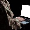 Soldier working with a laptop computer showing CMMC for DoD contractors