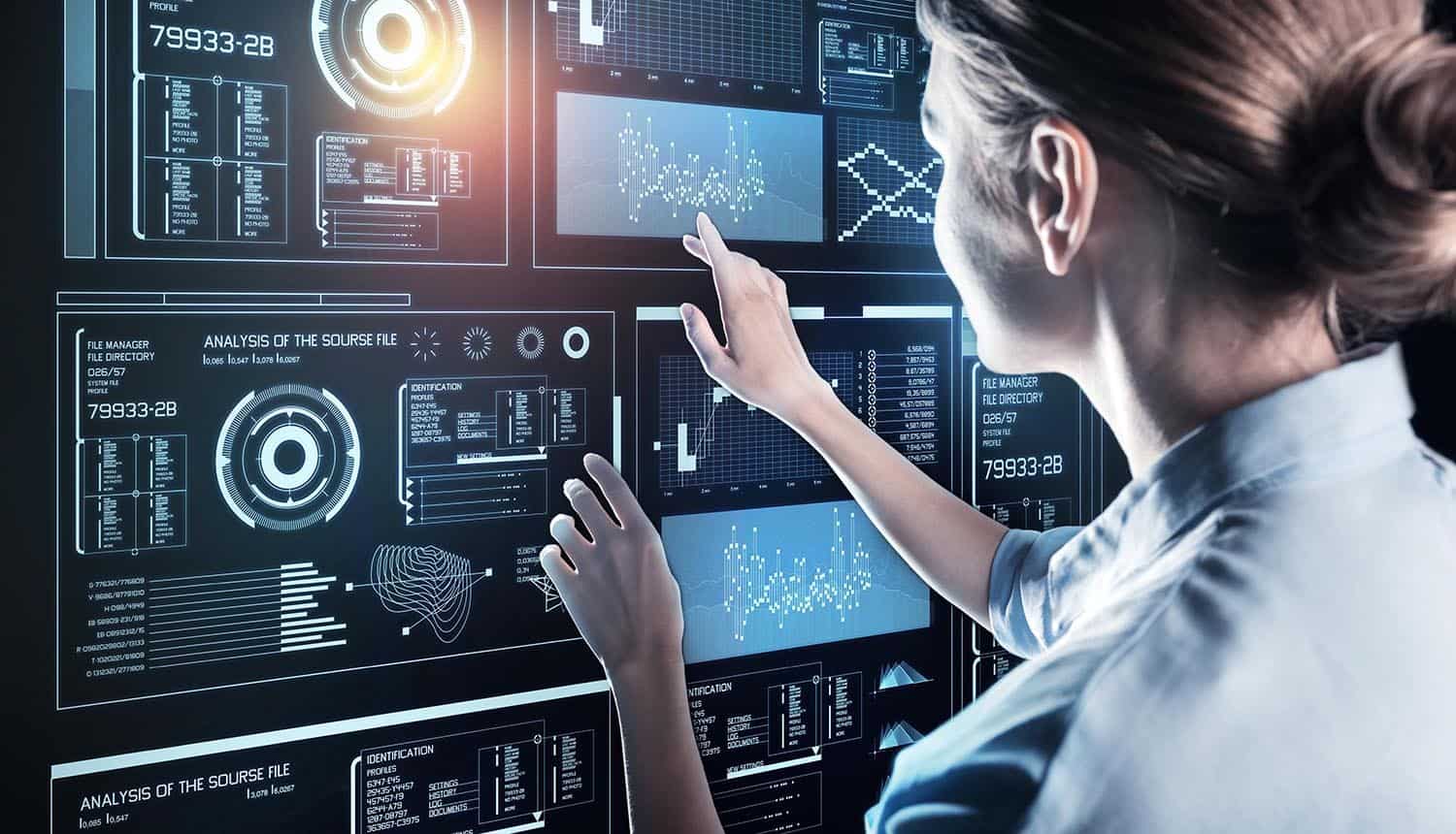 Woman working on touch screen of her futuristic device showing data remediation