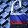 Open padlock on the computer keyboard with Russian flag showing Russian hackers targeting defense contractors