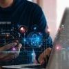 Man working on laptop with virtual lock icon protecting data showing data-centric security