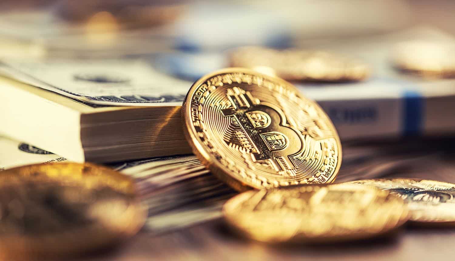 Bitcoins on dollar banknotes