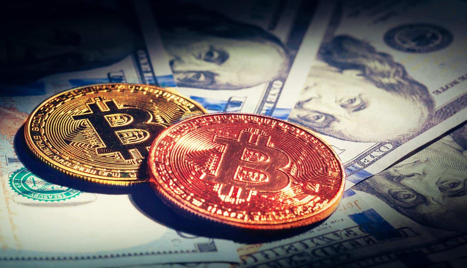 Golden bitcoin coins on paper dollars bills