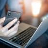 Man holding smartphone. using laptop and tablet showing zero trust architecture