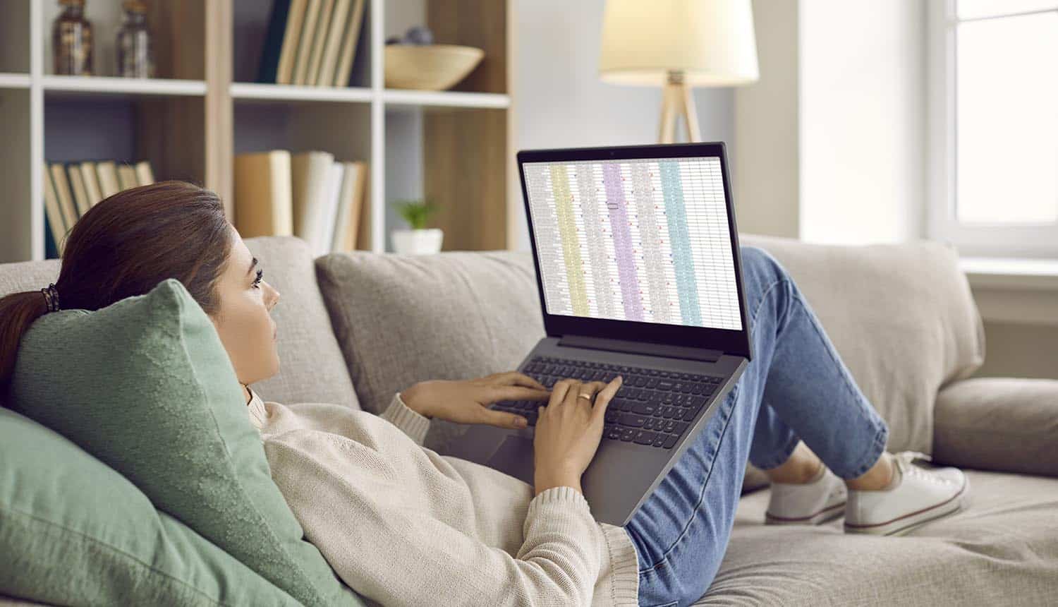 Remote employee relaxing on couch and working showing challenge of distributed remote workforce