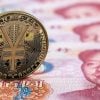 Digital yuan gold coin over yuan banknotes showing PBOC privacy protection for CBDC