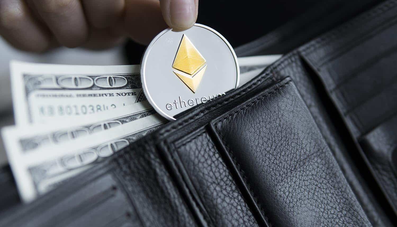 Ethereum coin and hundred dollars bills in leather wallet