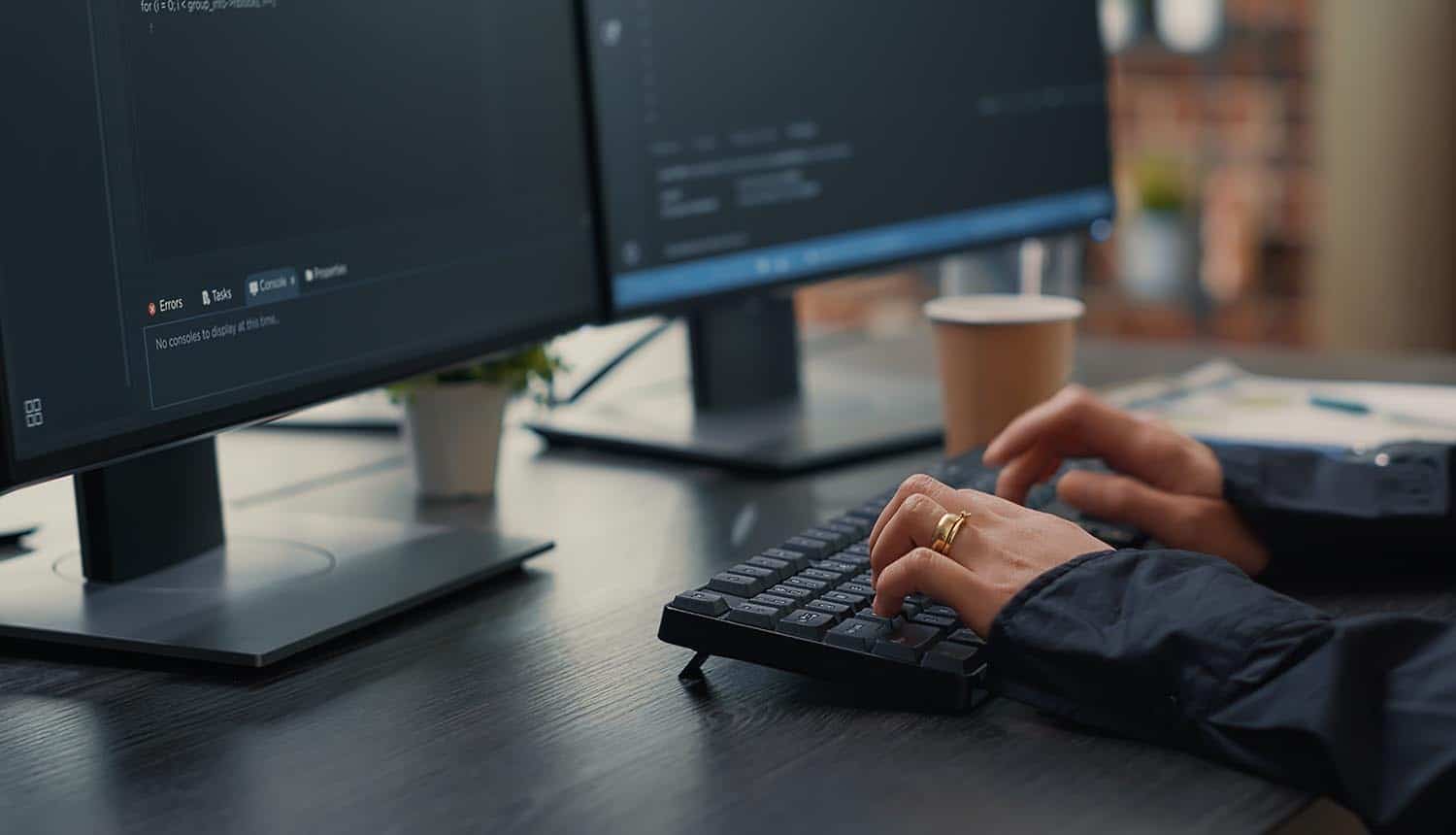 Software developer hands typing source code on keyboard