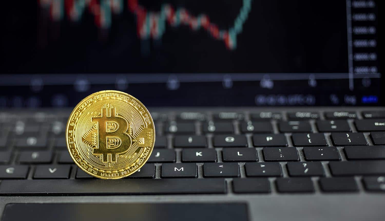 Bitcoin on computer with graph on background