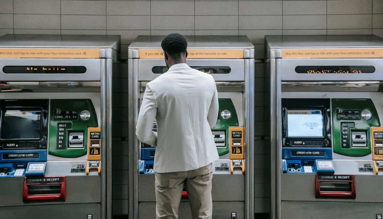 Man standing in front of ATM machine