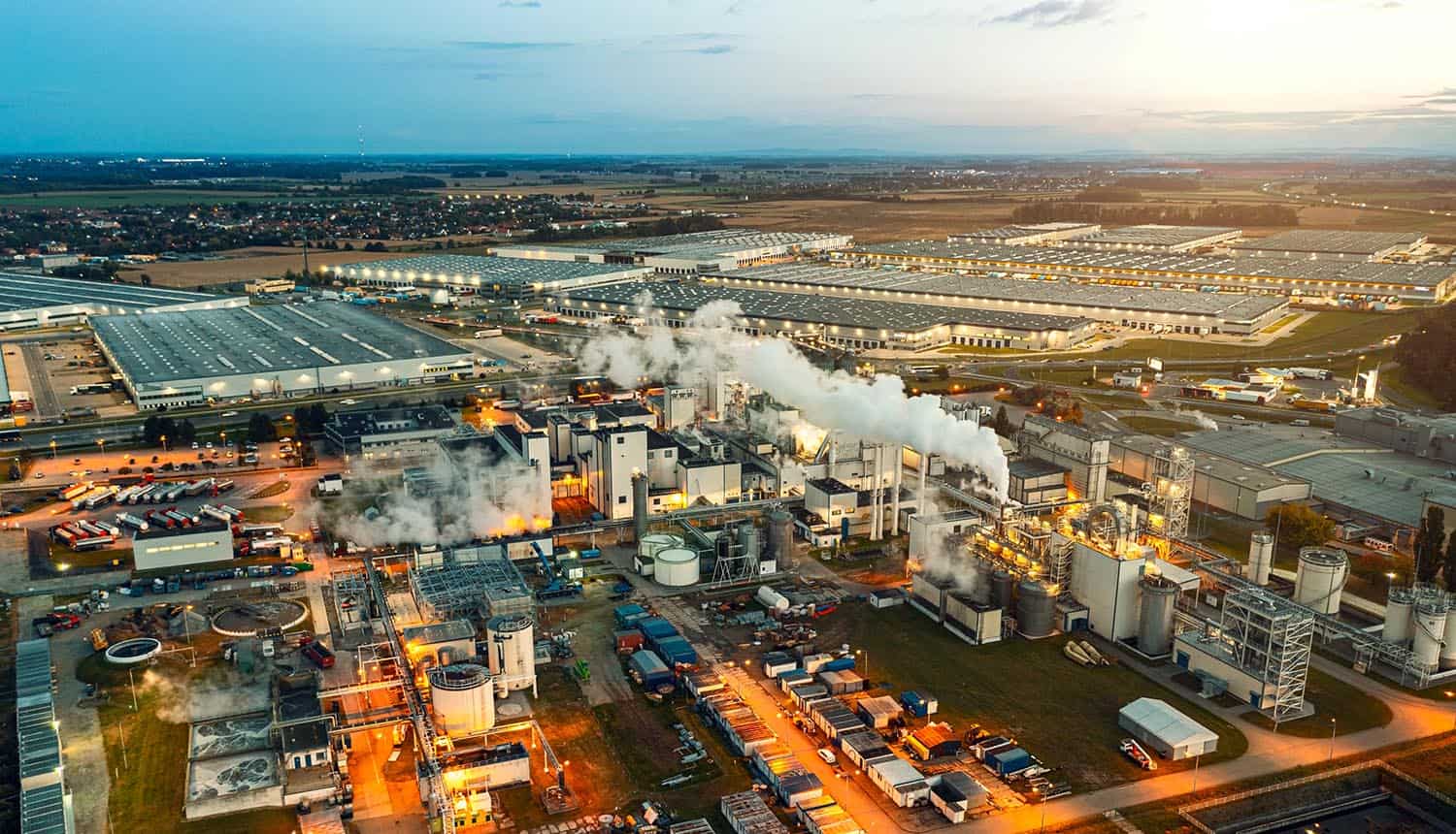 Top view at night on a large number of industrial enterprises showing ICS cybersecurity