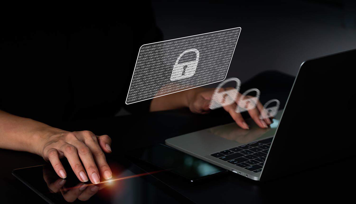 Businesswoman working on laptop computer with virtual locks