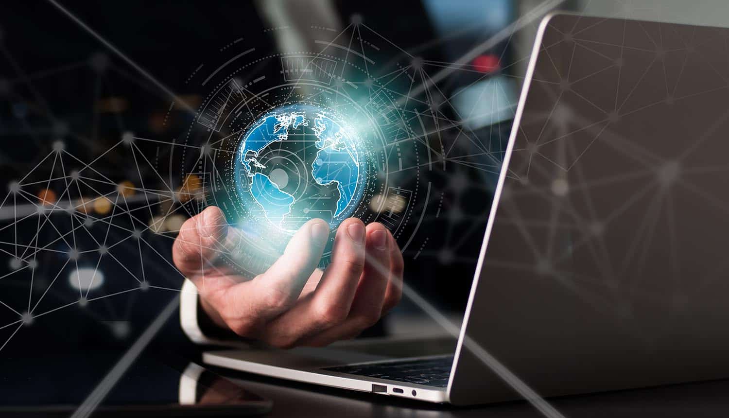 Businessman uses a laptop and holding virtual globe showing cybersecurity predictions