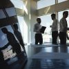 Silhouettes of people standing near a panoramic window showing privacy professionals and privacy skills gap