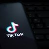 TikTok logo on smartphone showing emotion tracking and data collection