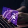 Woman using laptop showing fully homomorphic encryption and developers