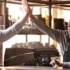 Barista giving high five to customer in coffeeshop showing consumer trust