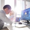 System hacked warning on monitor showing cost of data breach