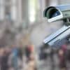 Security CCTV surveillance camera on wall showing Russian hackers