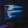 Backer using laptop and monitor showing cyber attack leaked code signing certificates