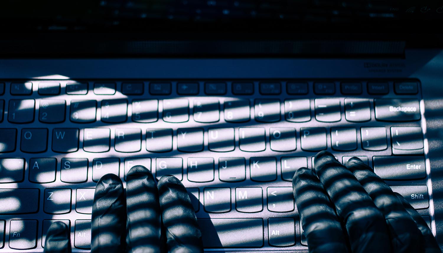 Hand typing on keyboard showing data breach at Canada foreign affairs department