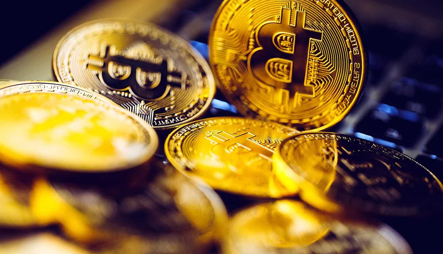 Bitcoin coins on laptop keyboard