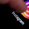 Finger tapping Instagram icon showing Ukrainian hackers hijack of email and Instagram accounts