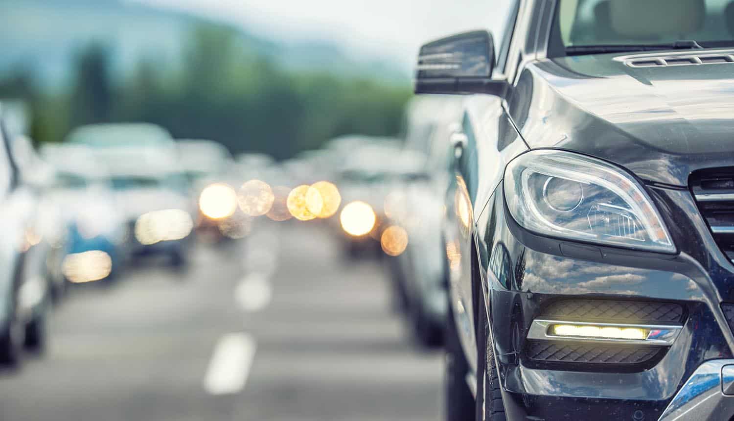 Cars waiting on the road showing cyber attack impact on auto dealers