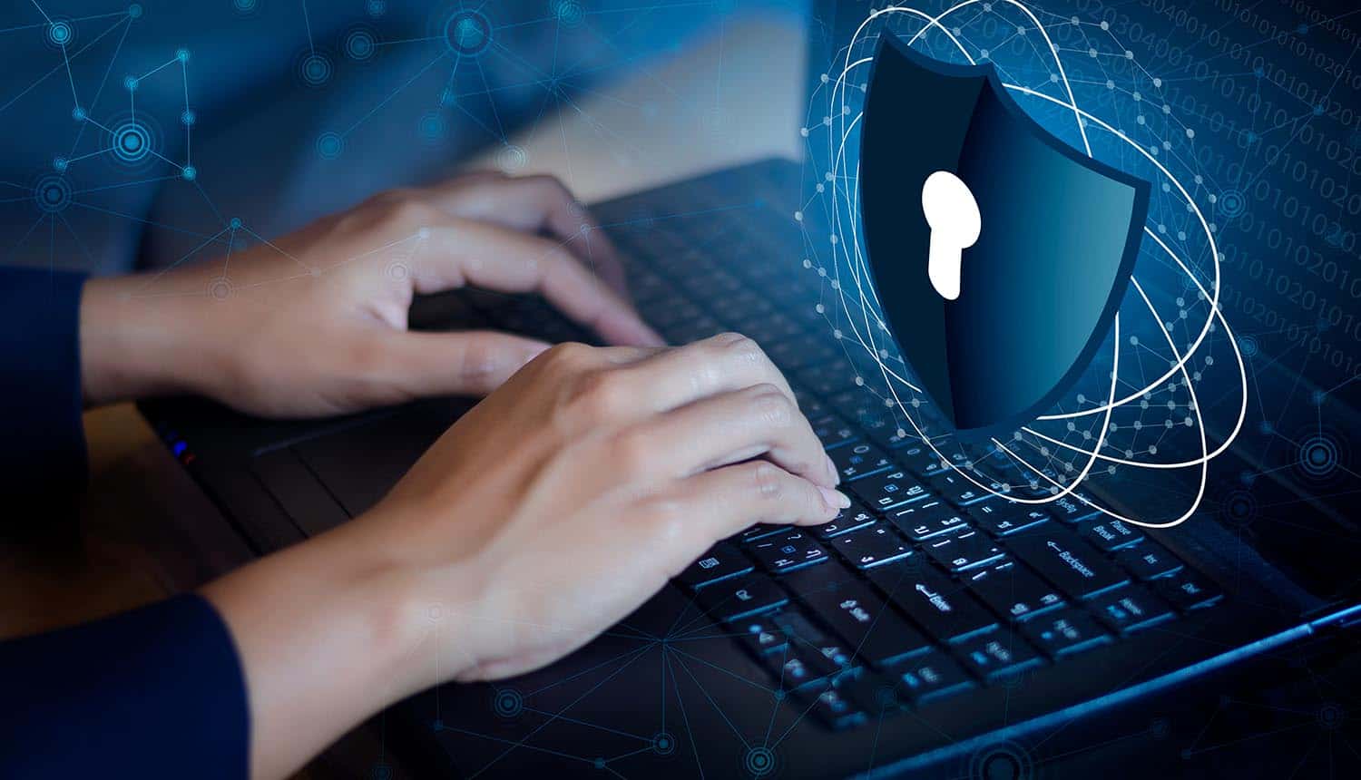 Hands typing on laptop