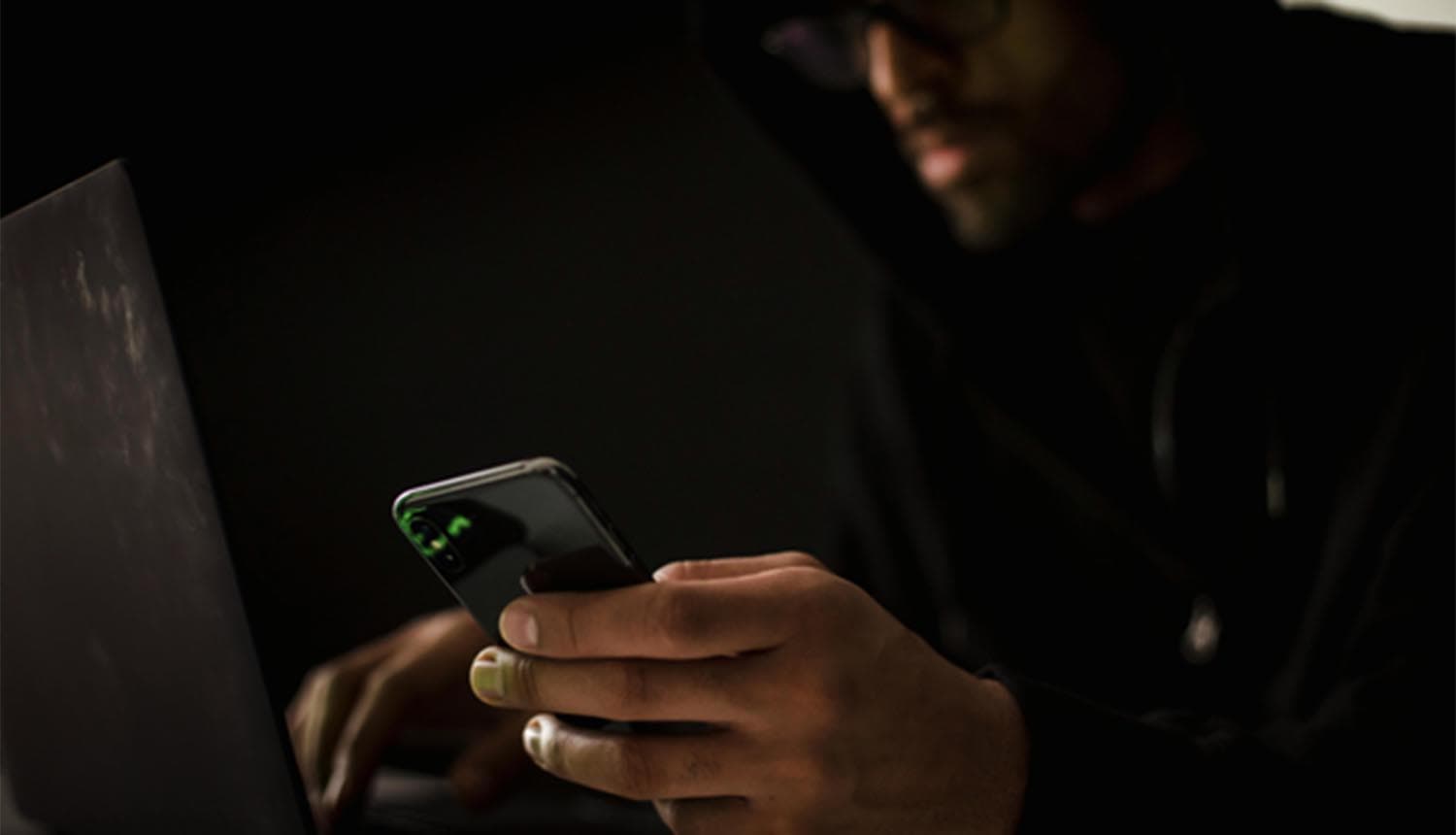 Hacker holding phone