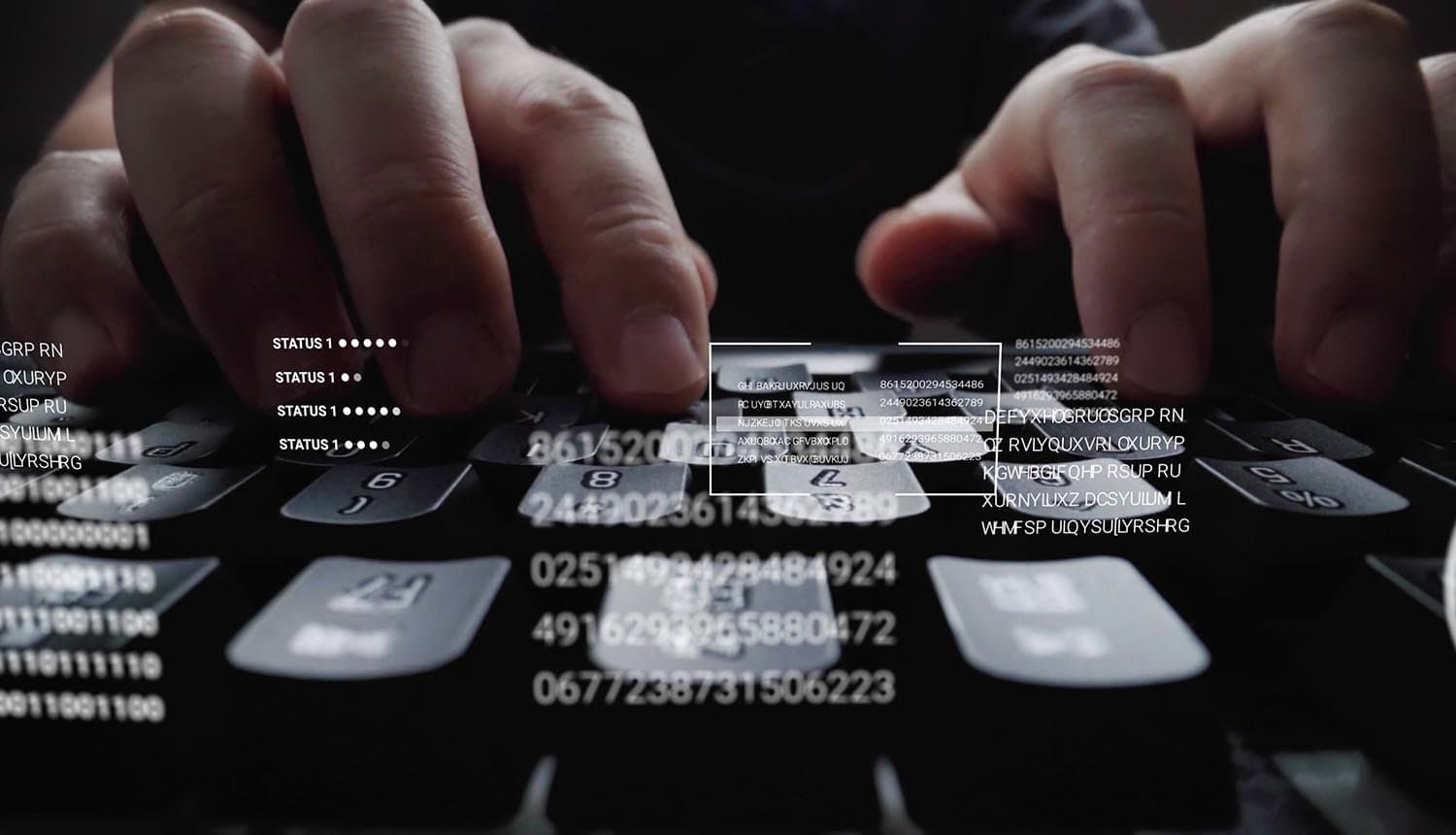 Man working on laptop showing ransomware attack