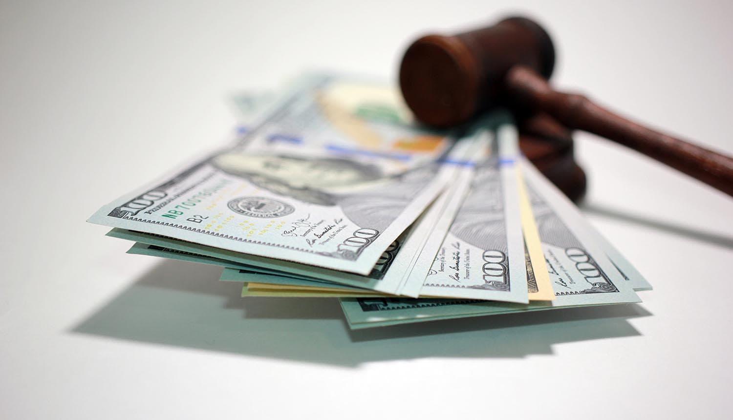 Judge hammer on dollar notes showing lawsuit settlement for data breach
