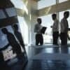 Silhouettes of people in office showing cybersecurity strategy and cyber risk
