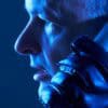 Cyber scammer using phone showing fake support numbers