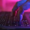 Hand on keyboard showing nation-state hacker