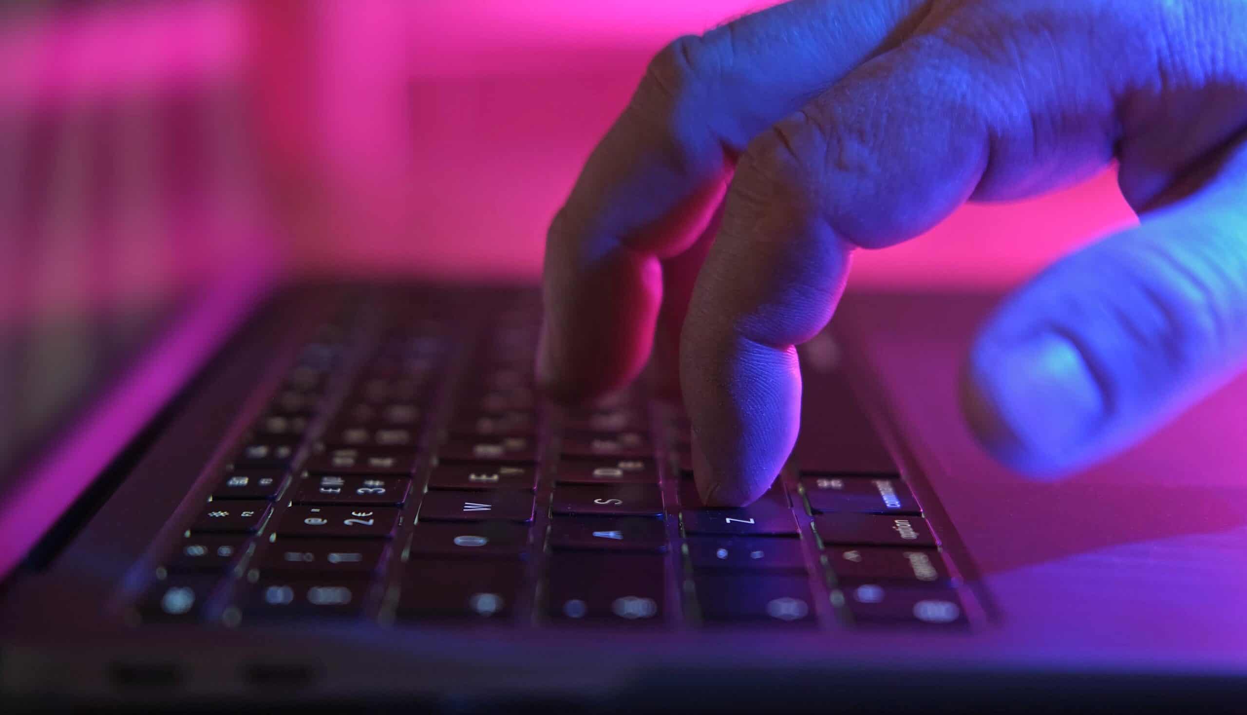 Hand on keyboard showing nation-state hacker