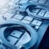 Computer keyboard and handcuffs showing arrests of suspects in cyber attack